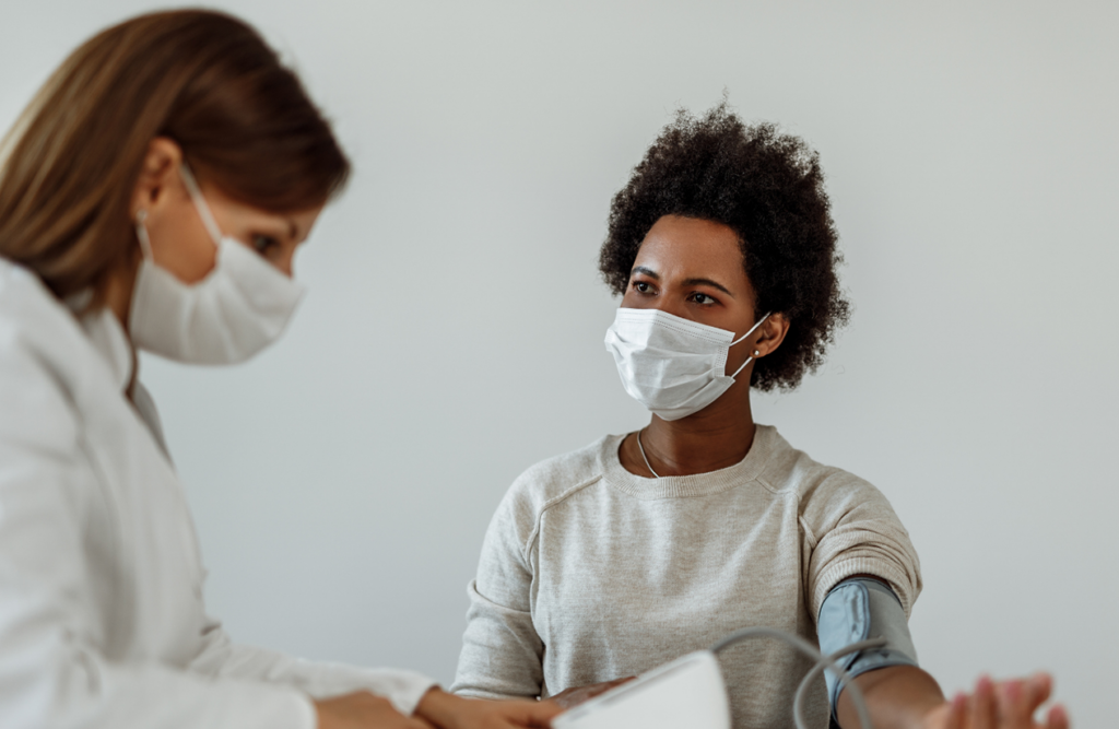 Healthcare worker and a woman performing a routine medical check